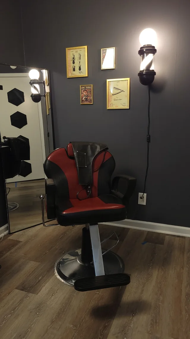 The signature red and black barber chair in the OTB studio